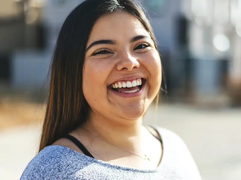 young woman smiling outdoors
