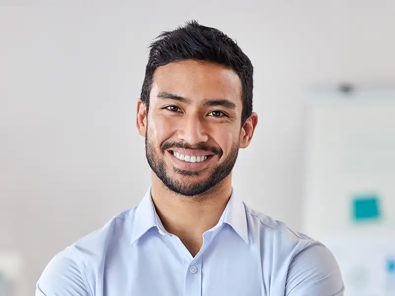 young man smiling in office