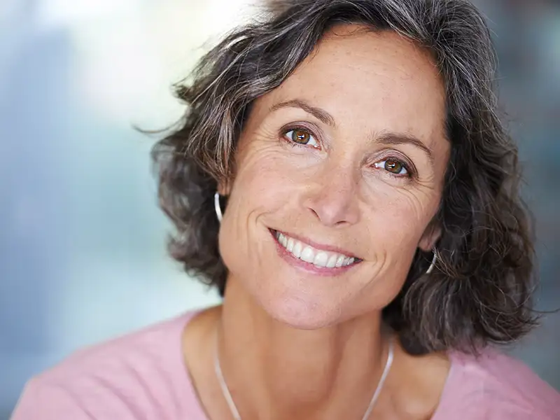 mature woman smiling indoors