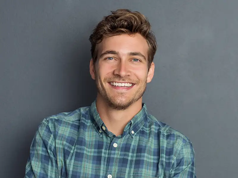 young man smiling indoors