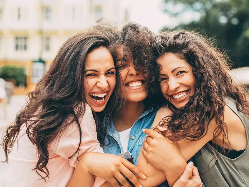 group of women hugging and smiling