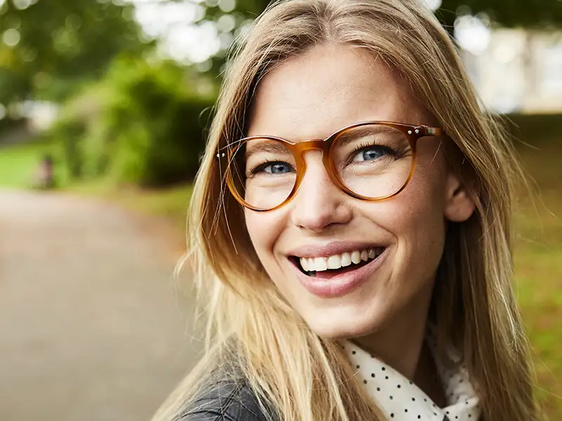 young woman smiling in the park