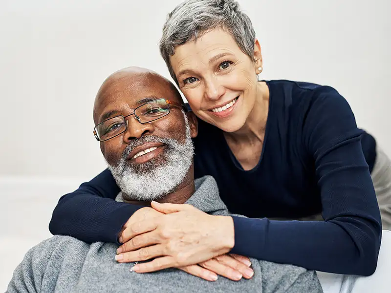 senior man and woman smiling together at home
