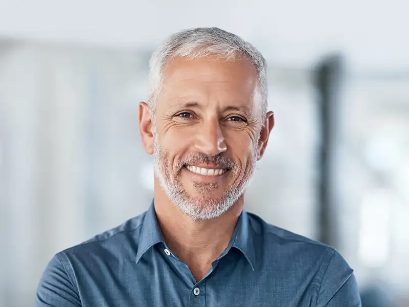 mature man smiling in office