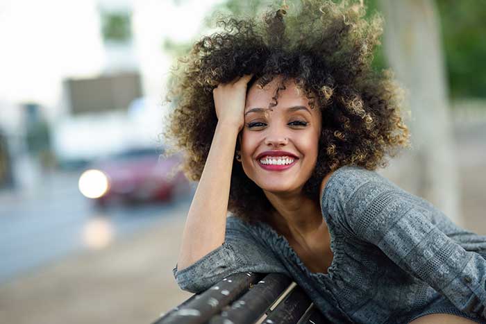 young woman smiling outdoors in the city