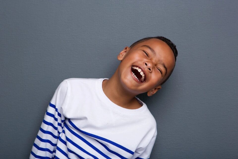 young boy laughing and smiling