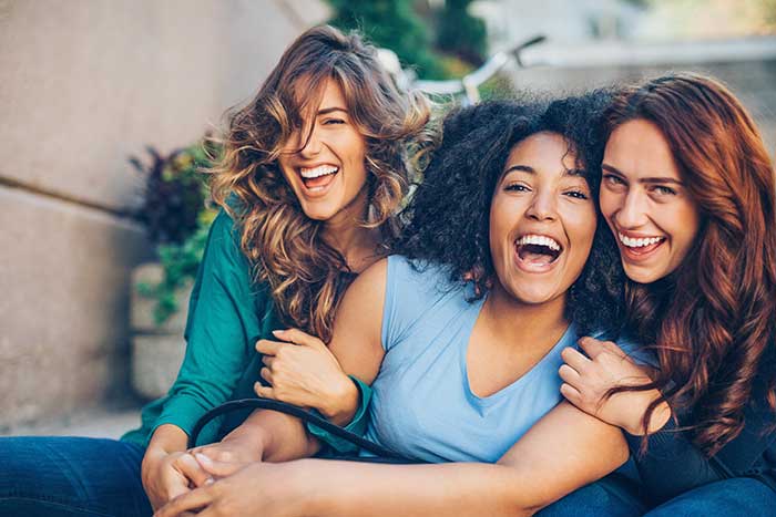 group of young women smiling and laughing