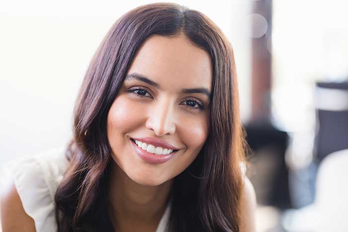 young woman smiling indoors at home